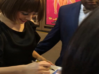 Happily signing for fans at the stage door