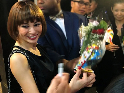 Graciously accepting flowers and gifts with a smile