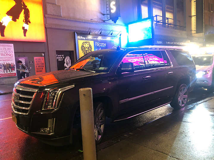 Two Cadillac Escalades waiting