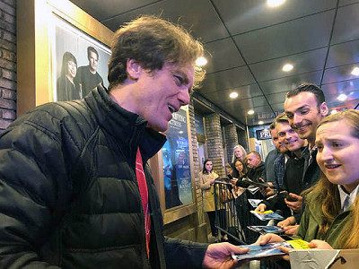 A few fans brought posters for him to sign