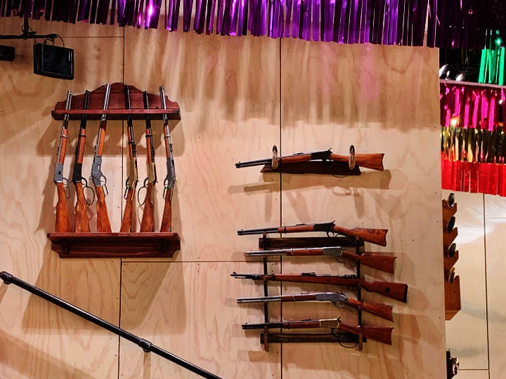 Rifles displayed on a theater wall