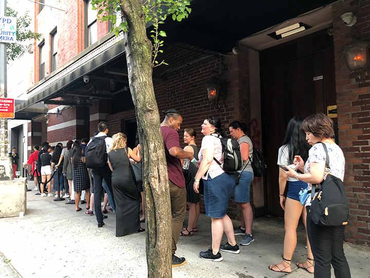 People in line with large bags and luggage