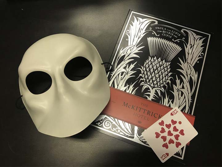Mask, playing cards, and the official guidebook