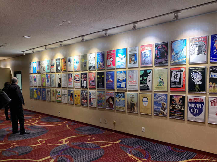 Hallway decorated with posters of past musicals