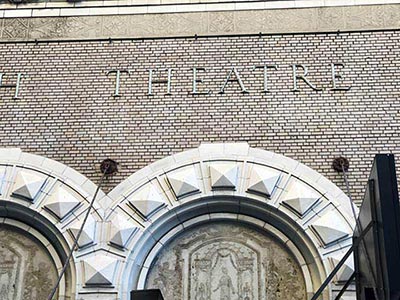 Sgraffito above the entrance arch of the Booth Theatre