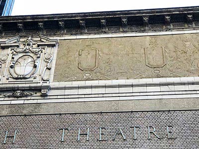 Sgraffito next to the Booth Theatre crest
