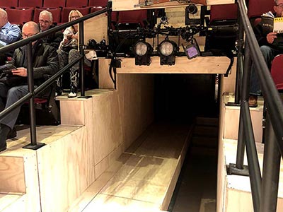 Entrance and exit using the vomitorium, where cast members enter the stage