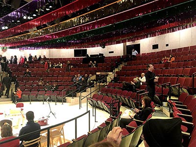 The thrust stage surrounded on three sides by the audience, making the performance feel closer than in most theaters
