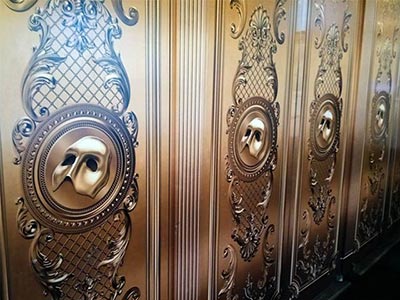 The lobby doors decorated with the Phantom mask, enhancing the theater’s atmosphere
