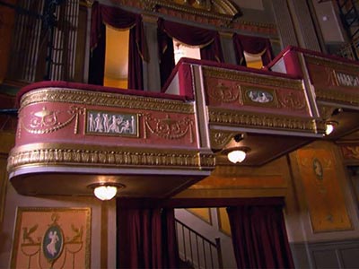 Box seats decorated in Adam style with gold accents