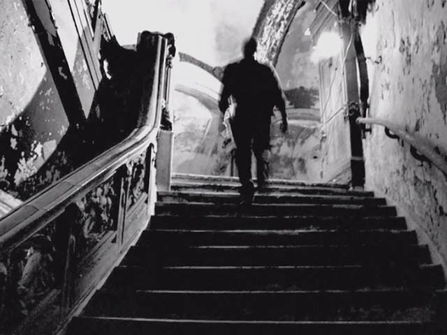 The coating on the theater stairs is peeling off and damaged in many places.