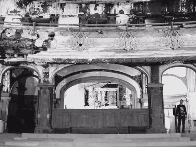 Theater interior covered with mold and moss due to humidity
