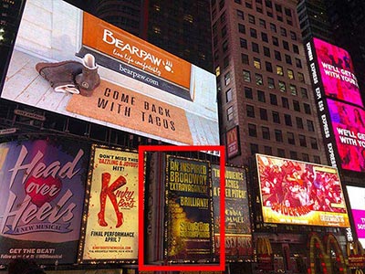 The Palace surrounded by Broadway signage