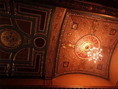 Delicate red toned decorations on the ceiling at the Walter Kerr Theatre